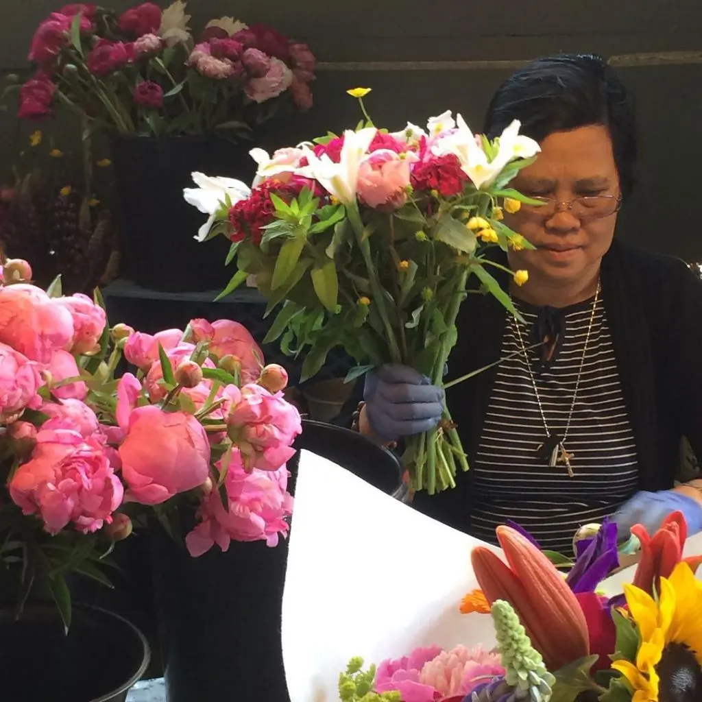 Woman making a boquet at pike place market