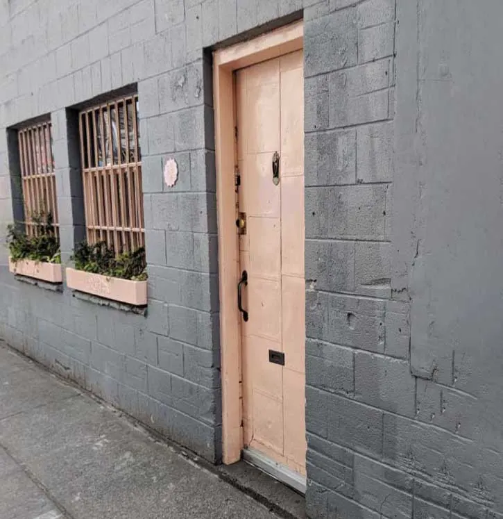 This nondescript pink door is the access point for one of the market's best restaurants