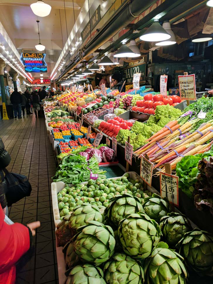 Fruit lined up at pike place market shows that shopping local markets is a way to experience travel while eating a little healthier.