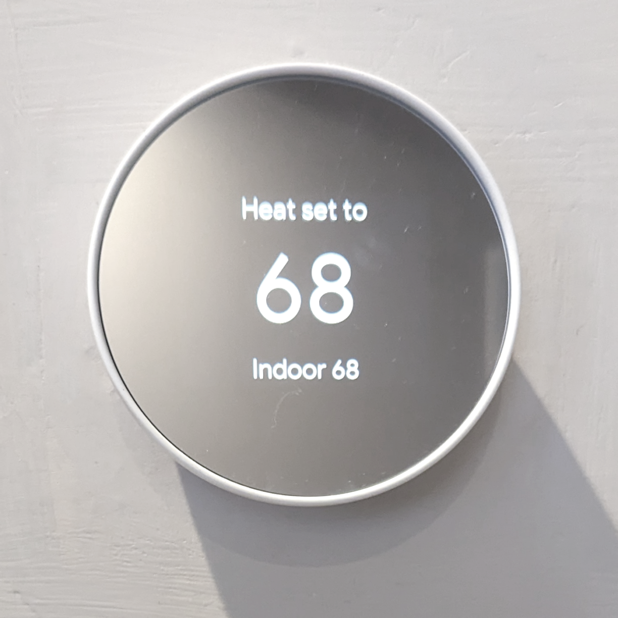 A google nest thermostat installed on the wall of my airbnb rental.