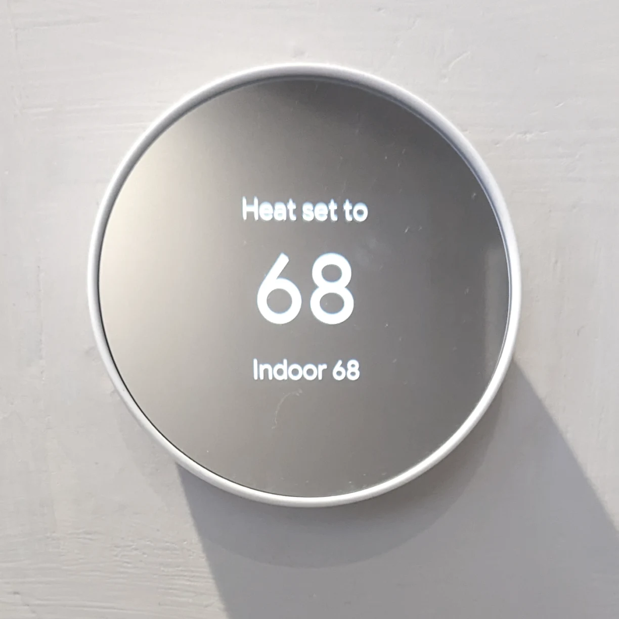 A google nest thermostat installed on the wall of my airbnb rental.