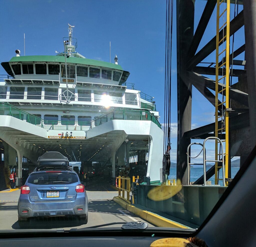 Cars pulling onto a wsf ferry.