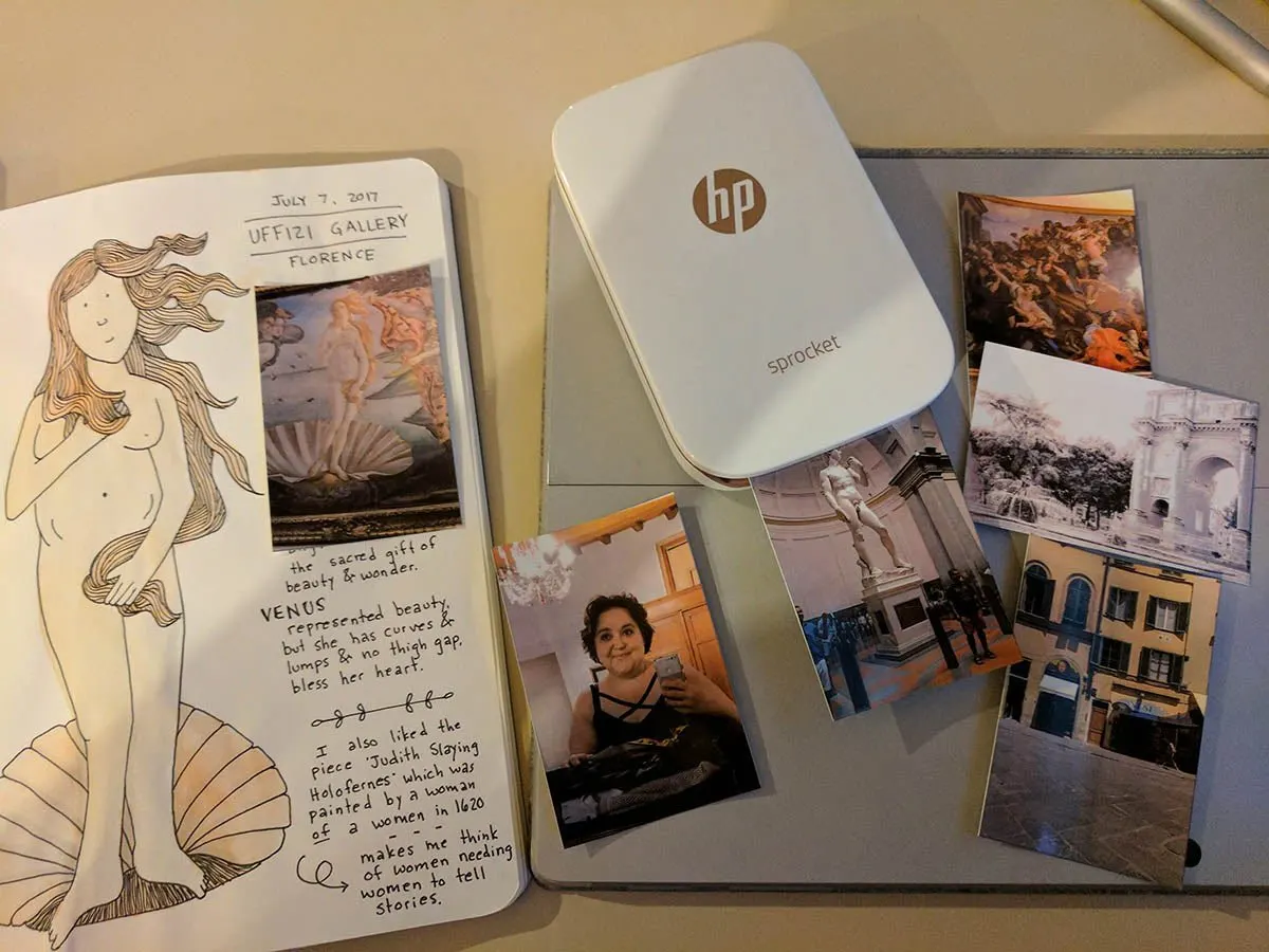 A travel printer shown next to a travel journal.