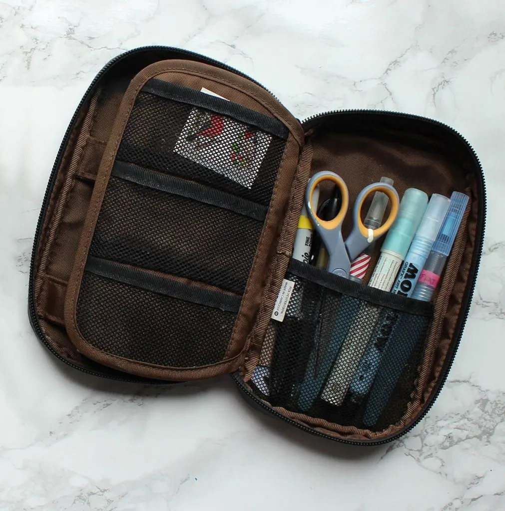 A pen case with pockets is essential and prevents everything from falling out at once if the case is dropped or overstuffed.