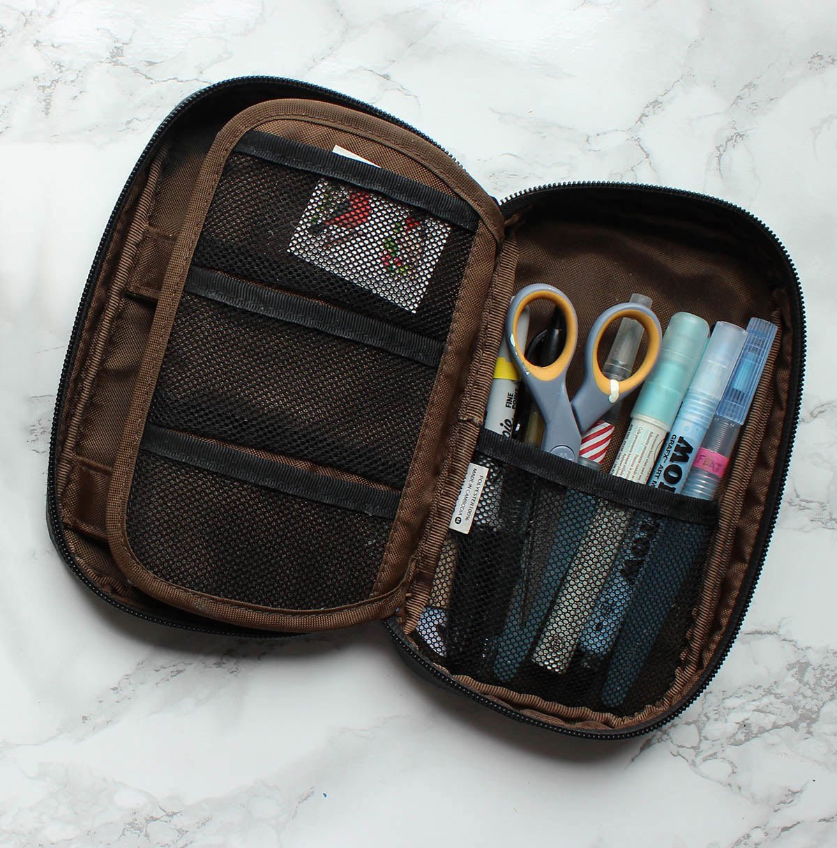 A pen case with pockets is essential and prevents everything from falling out at once if the case is dropped or overstuffed.