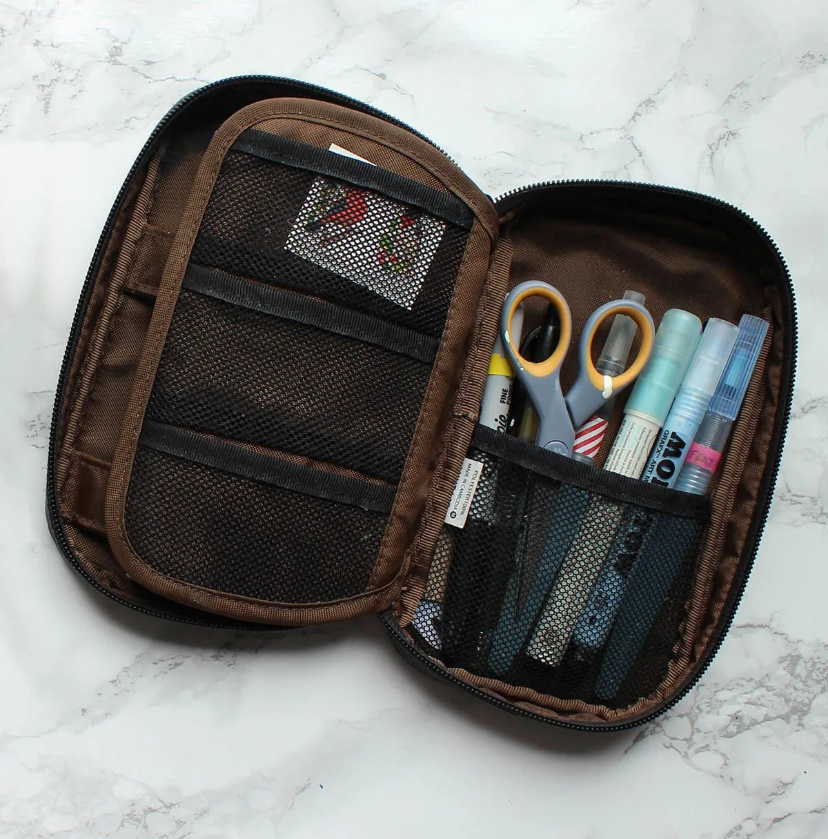 A pen case with pockets is essential and prevents everything from falling out at once if the case is dropped or overstuffed.