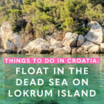 Turquoise green waters of the adriatic sea with craggy rocks and trees.