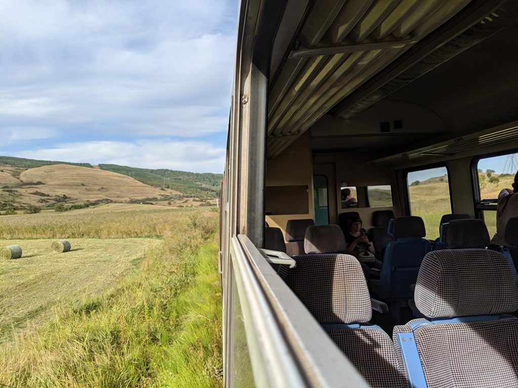 A photograph of the romanian countryside from the window of a train.