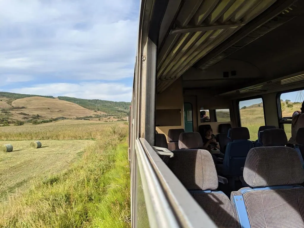 A photograph of the romanian countryside from the window of a train.