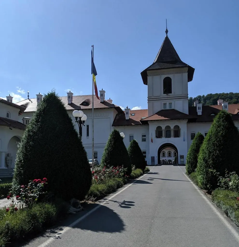 A large white monastery and landscaped path.