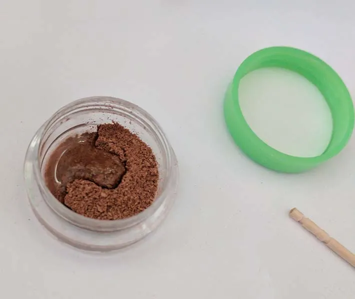 Adding rubbing alcohol to the loose powder.