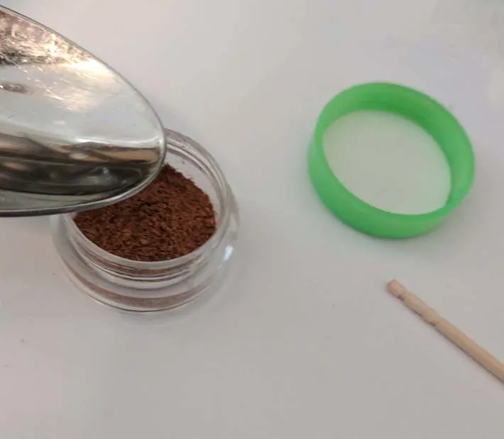Adding rubbing alcohol to the loose powder.