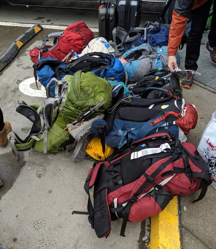 A pile of backpacks on a curb in south america