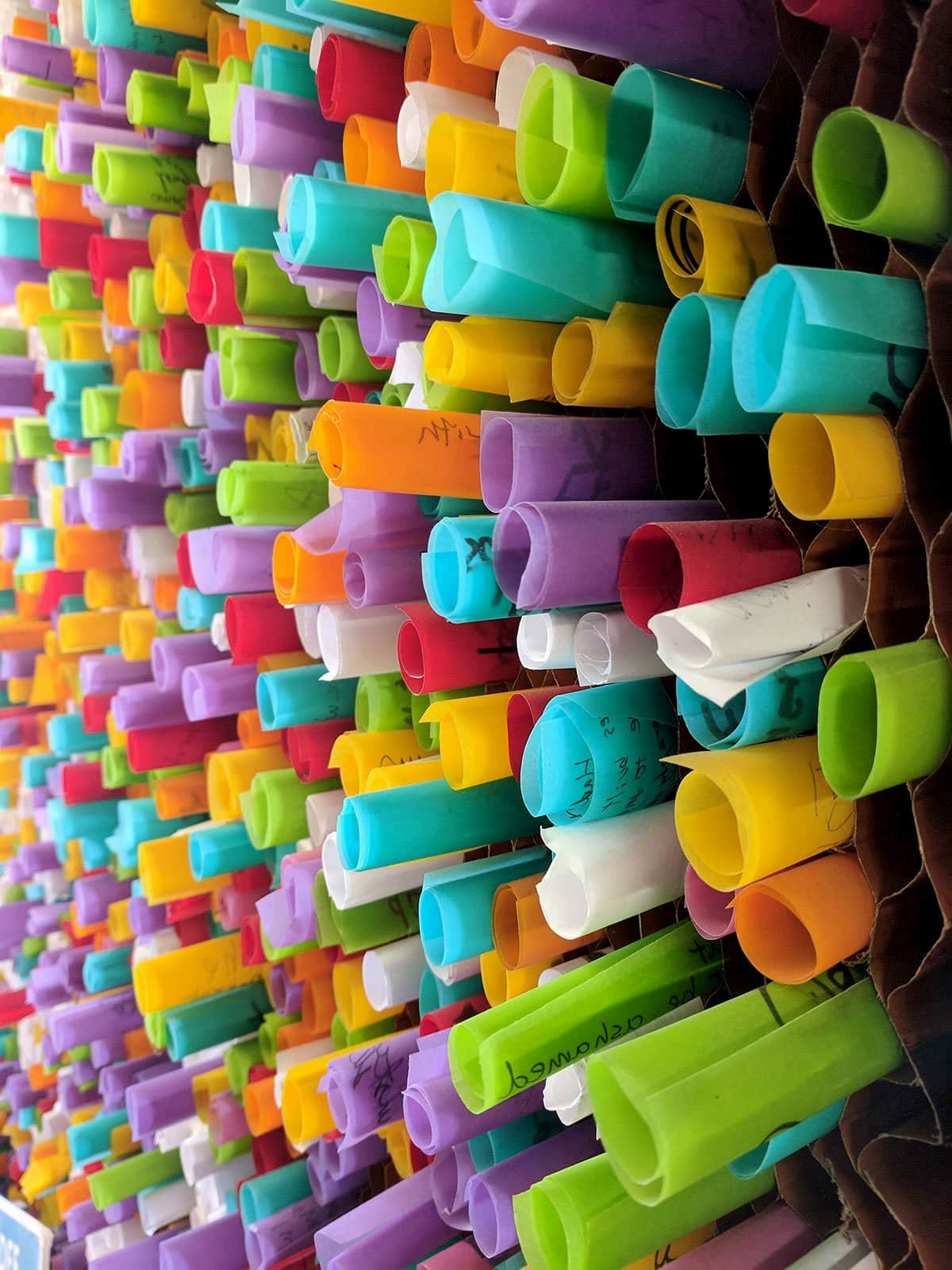 Colored paper rolled and inserted into hexagonal paper create an interactive mosaic.