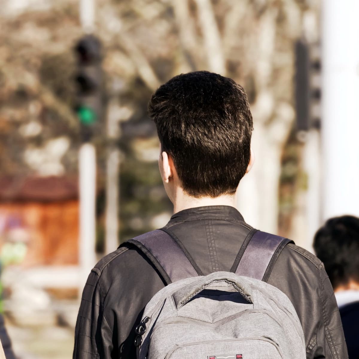 Man with a backpack in an urban area.