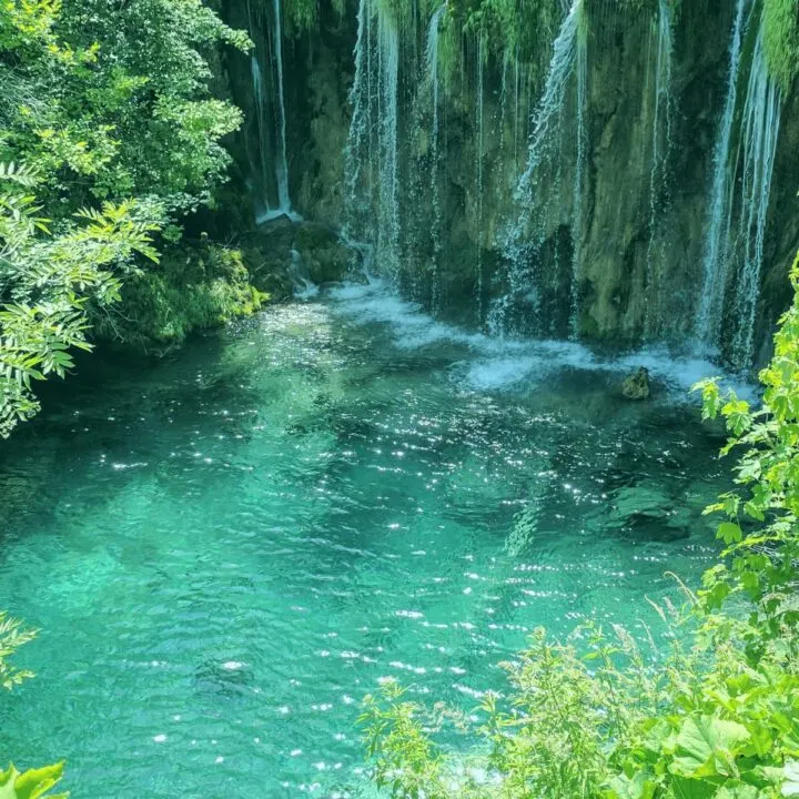 Tropical-looking blue green waterfall in Plitvice National Park.