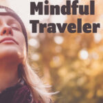 A female traveler closes her eyes to savor the nature around her.
