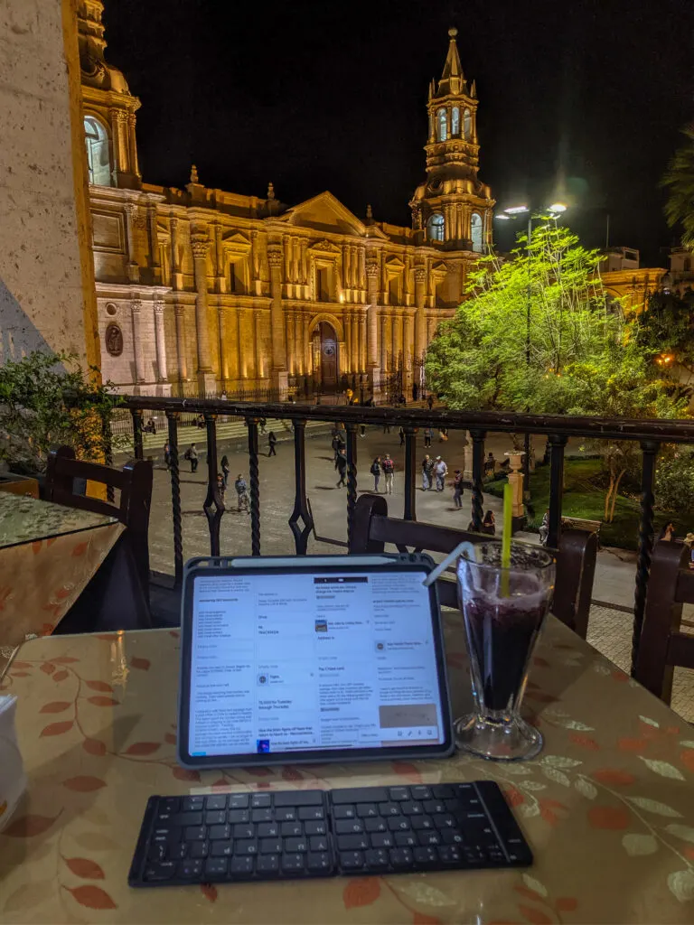 A portable screen on a balcony overlooking a city square in peru, as i worked as a digital nomad.