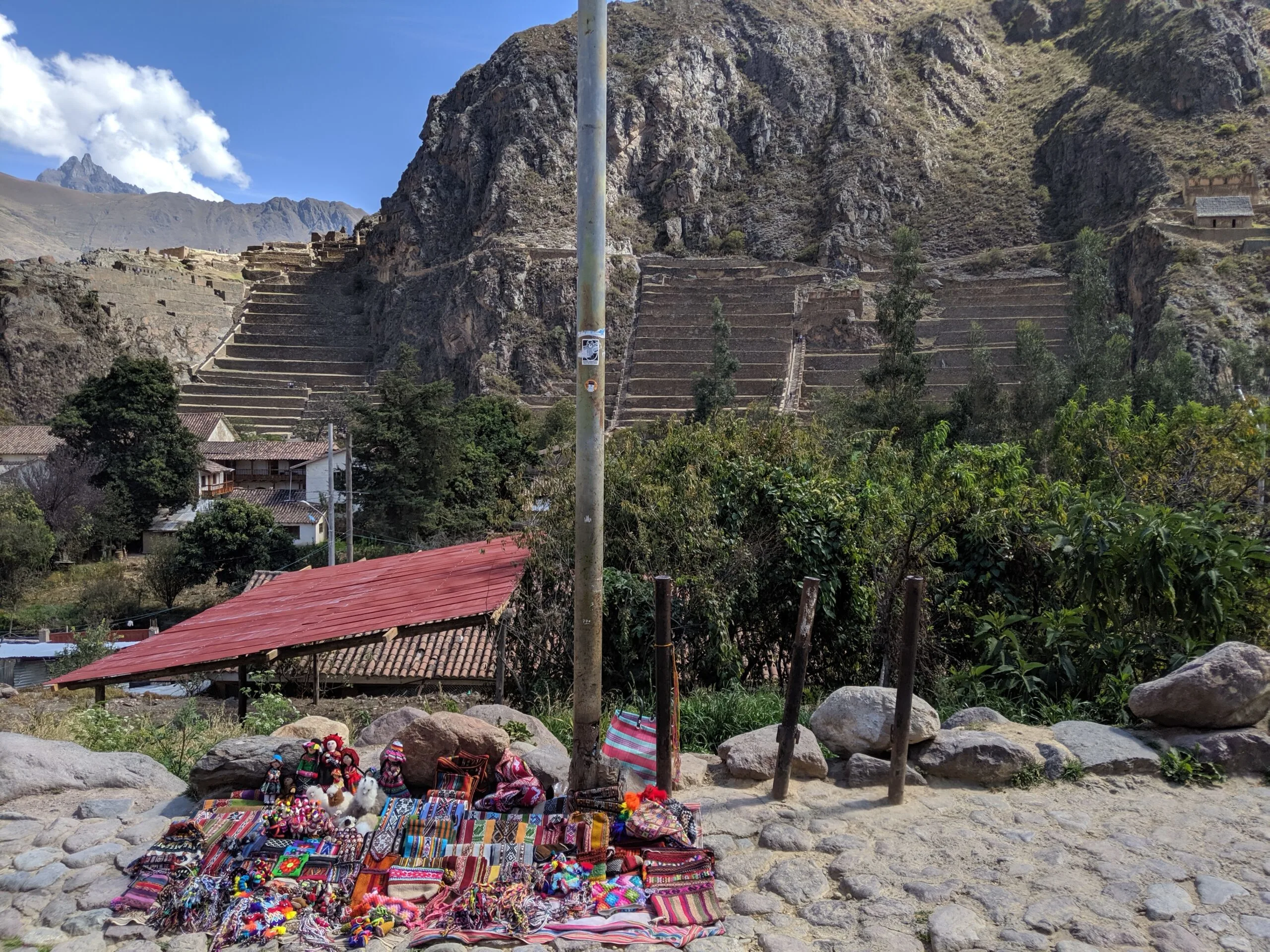 Contrast of ruins vs modern buildings in ollantaytambo, peru.