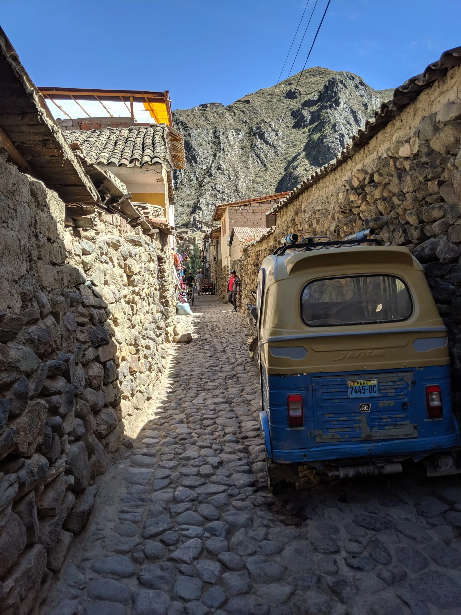 A small van sites in a narrow road in peru.