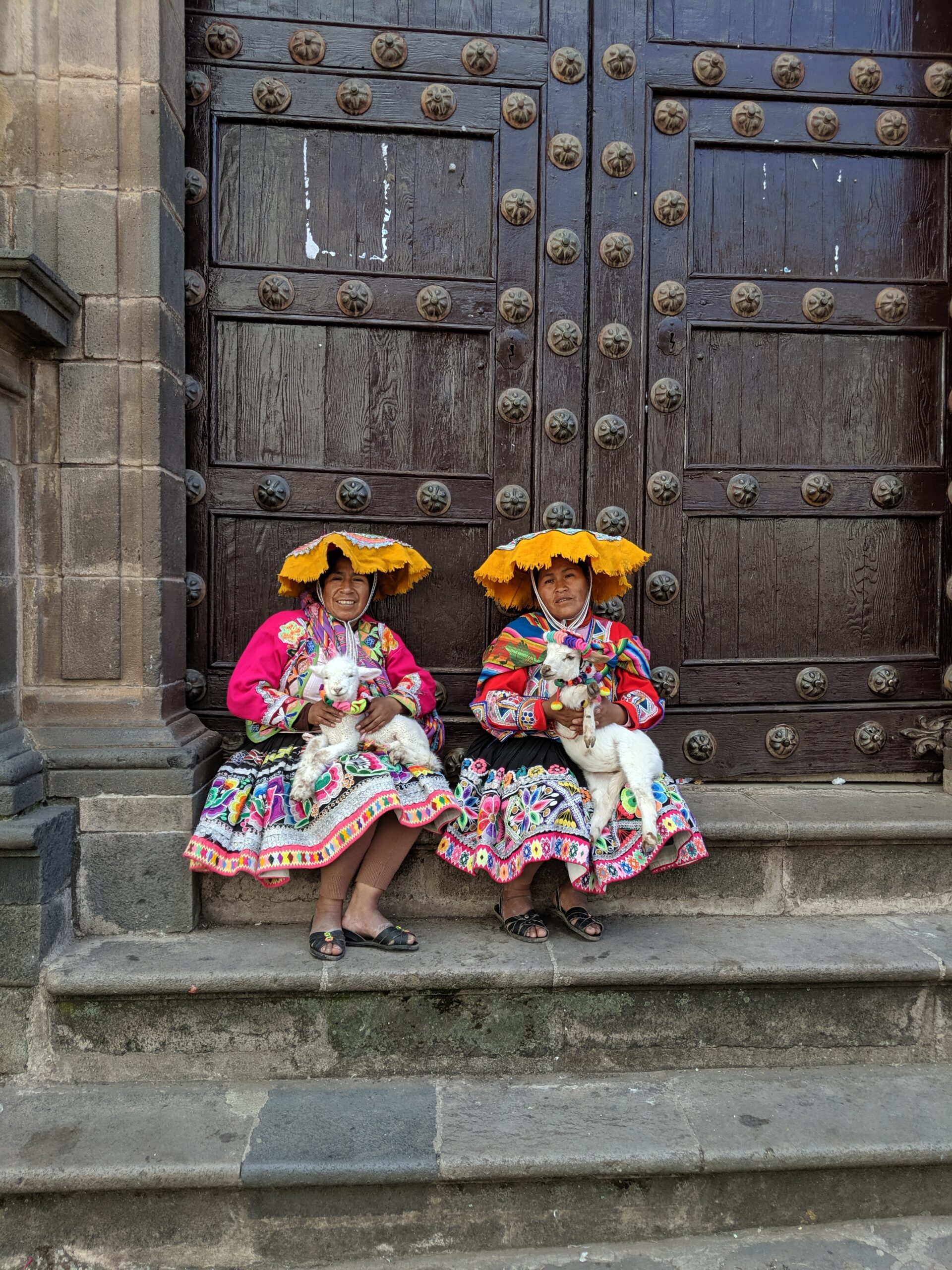 Two women pose in traditional peruvian clothing
