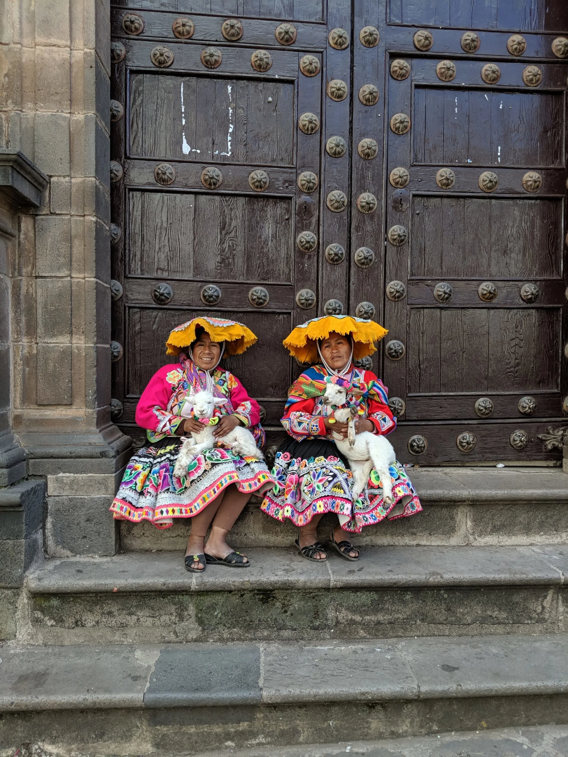 Two women pose in traditional peruvian clothing