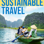 Tourists in a traditional boat in asia snap a selfie while a tour guide paddles.