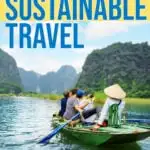 Tourists in a traditional boat in asia snap a selfie while a tour guide paddles.