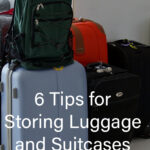 A group of suitcases and backpacks sit in a storage area.