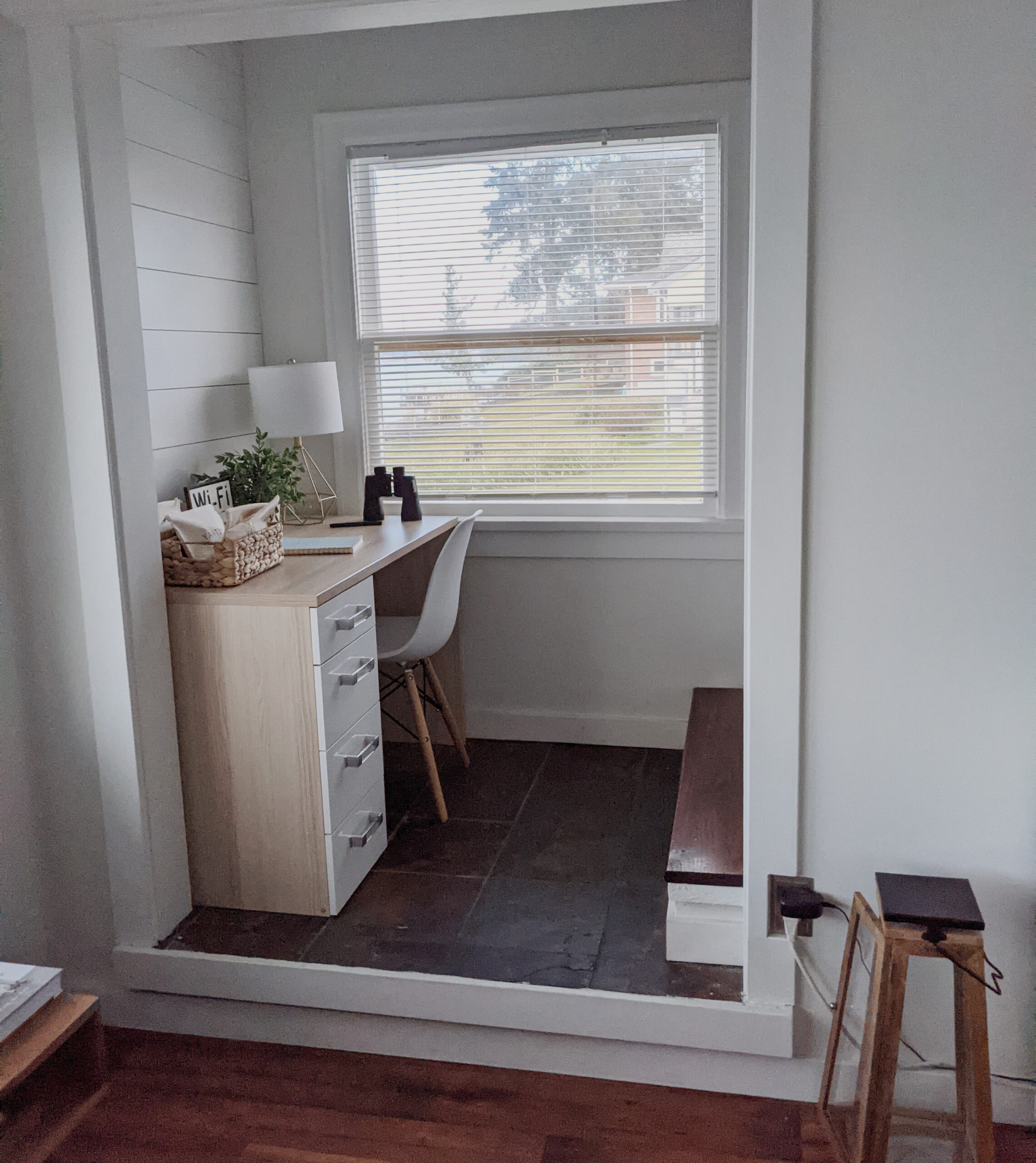 An airbnb office nook with an unsuitable chair.