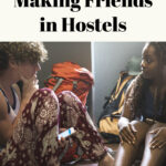 10 secrets for making friends in hostels is written in text over an image of two travelers having a conversation in a hostel.