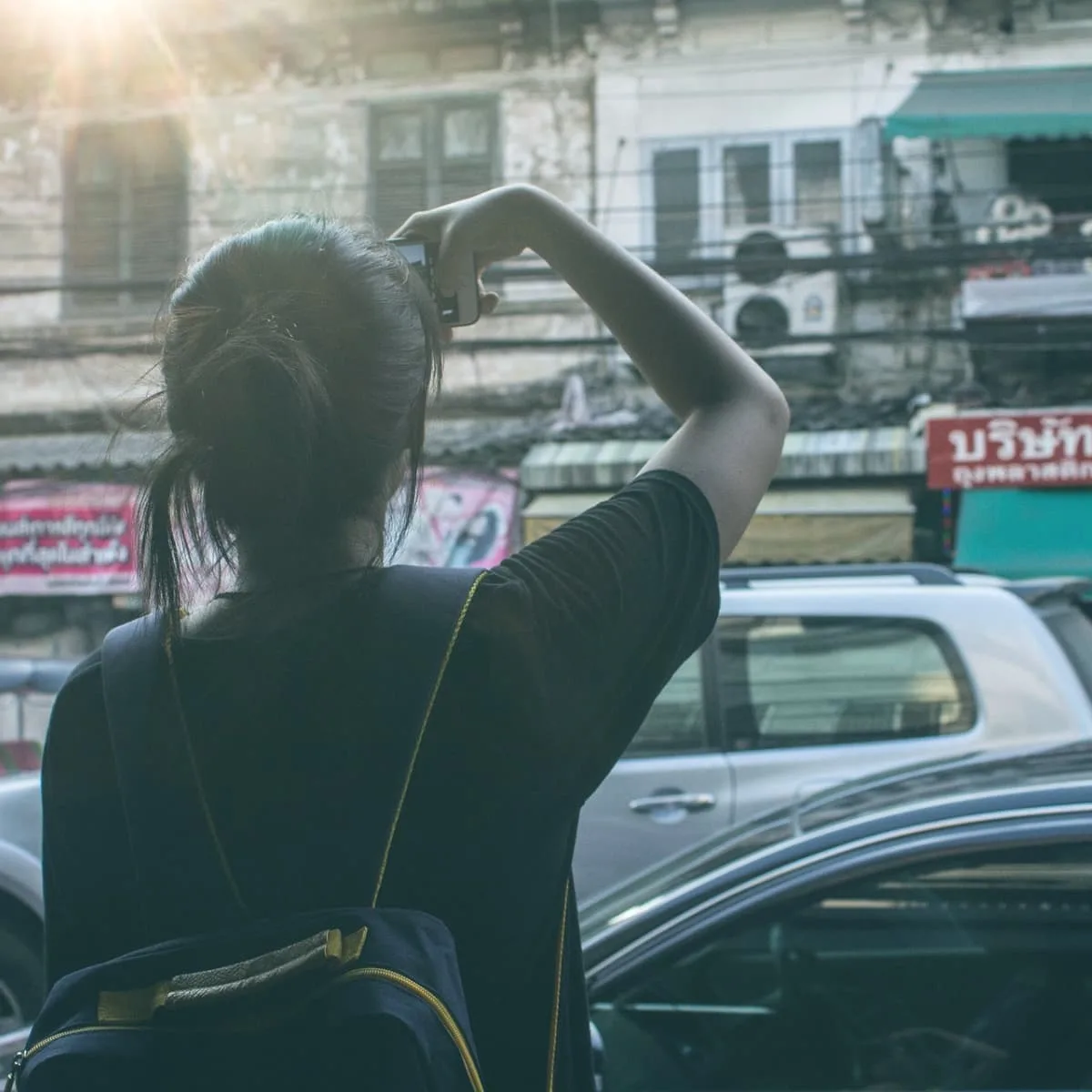 A tourist in asia taking a photo.