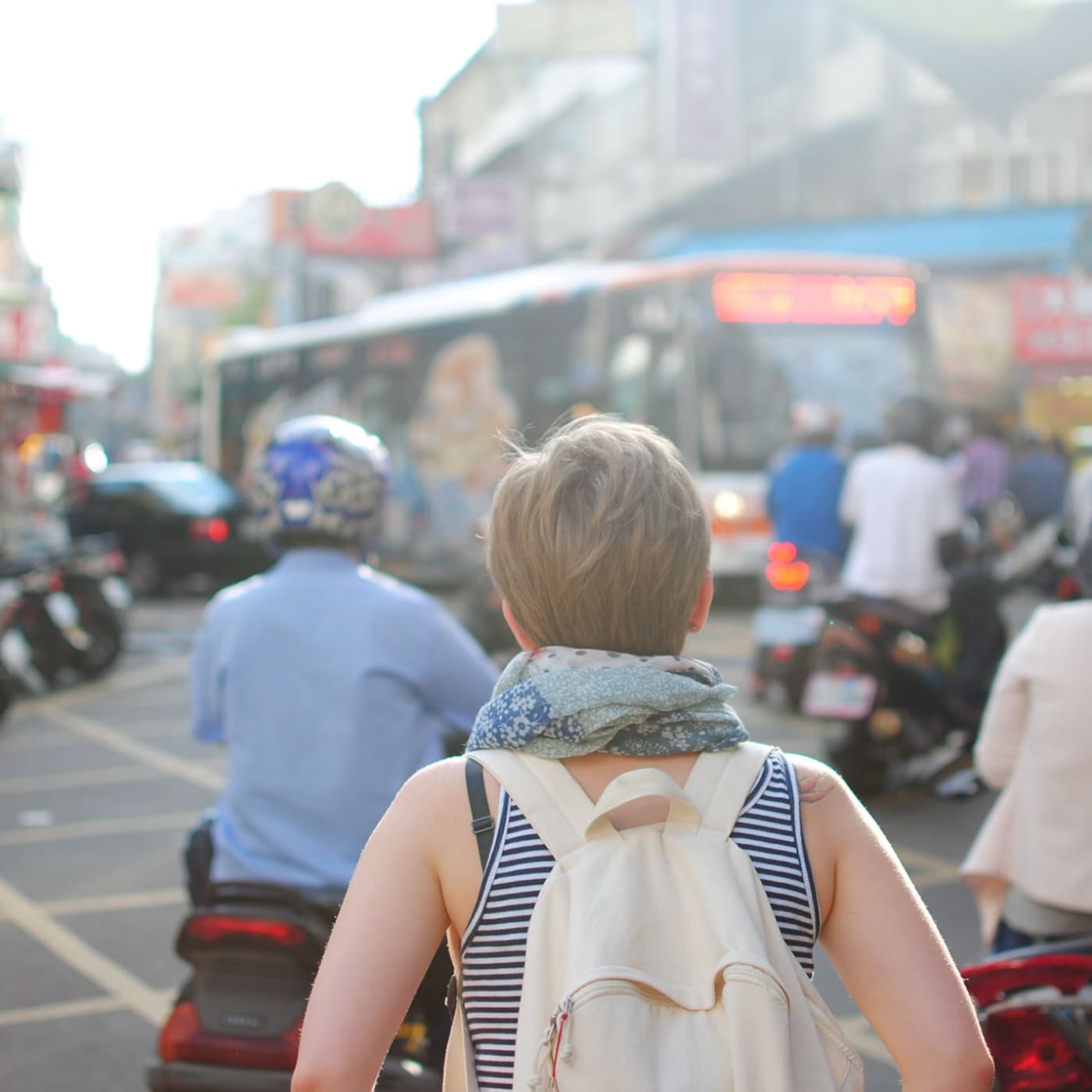 Woman walking in a crowd.