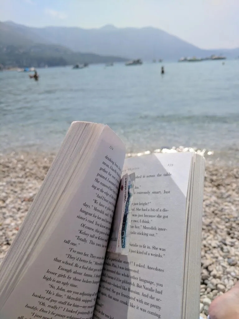 Image of a book being read on the beach