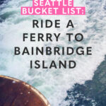 Text reads: seattle bucket list: ride a ferry to bainbridge island with an image of a ferry wake in the background.