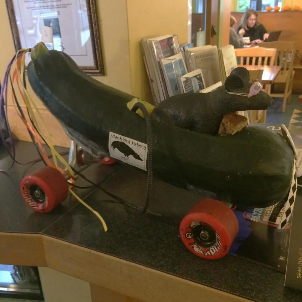 A plastic mouse in a racing zuchinni.