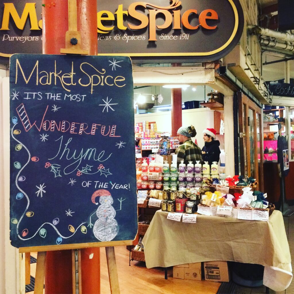 Pike place market herb store with christmas sign.