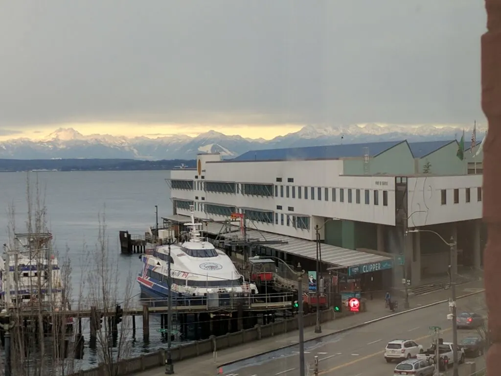 View of the clipper ferry terminal in seattle, with mountains behind.
