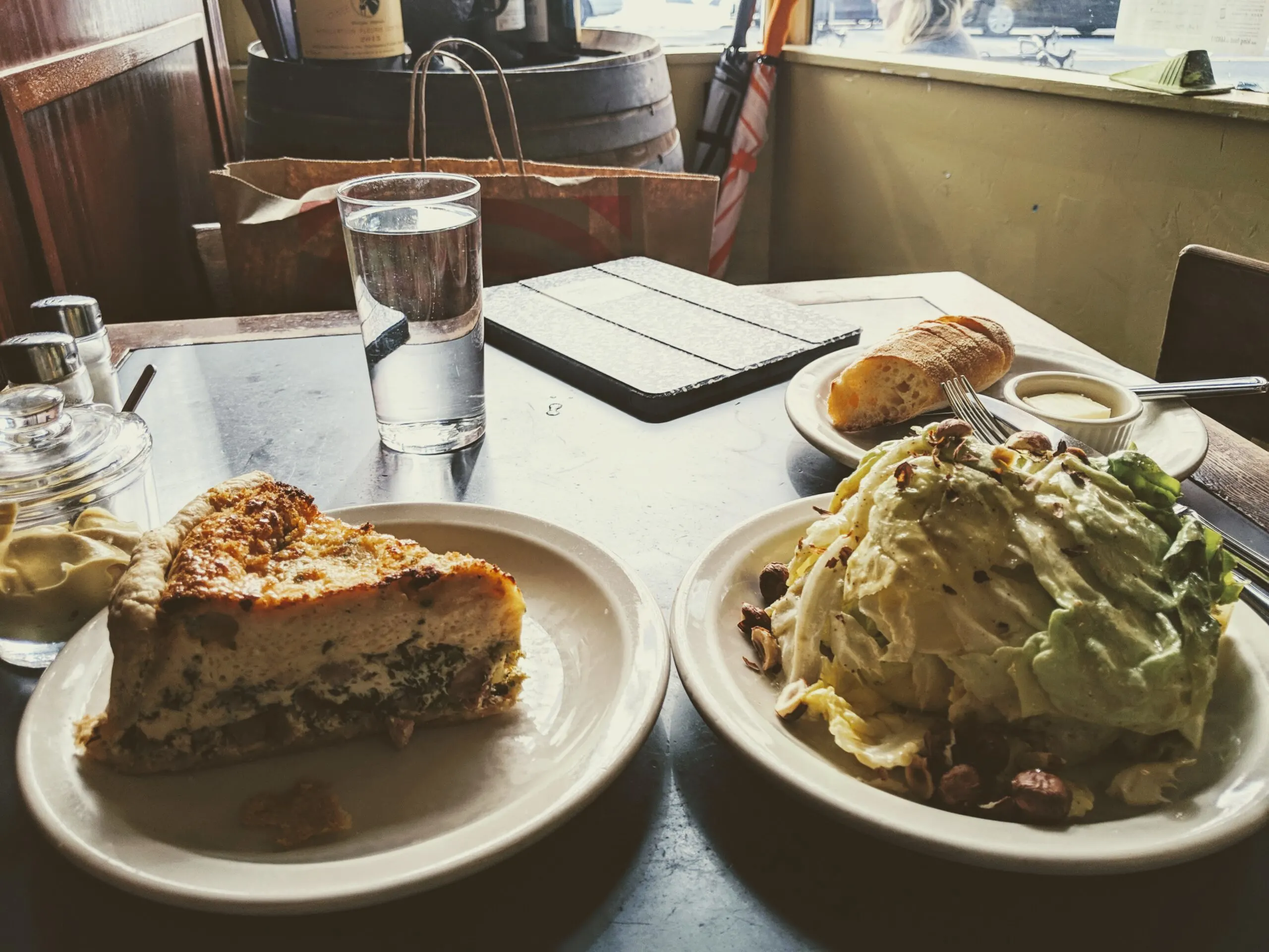 Quiche and a salad pictured on a table at le panier restaraunt.