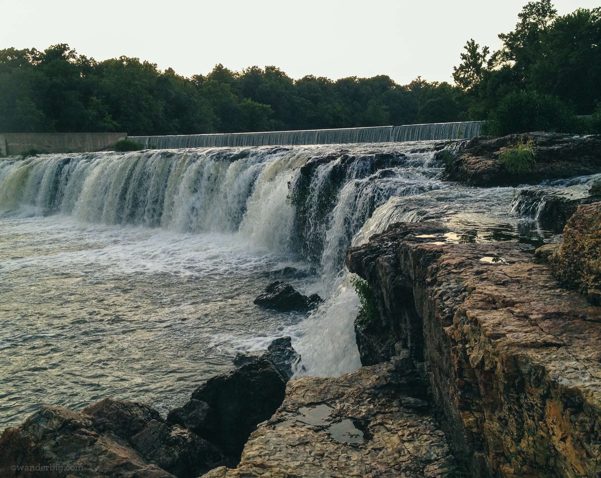 Spring fed waters from shoal creek flow over the chert rock formation making up grand falls waterfall, near joplin, mo.
