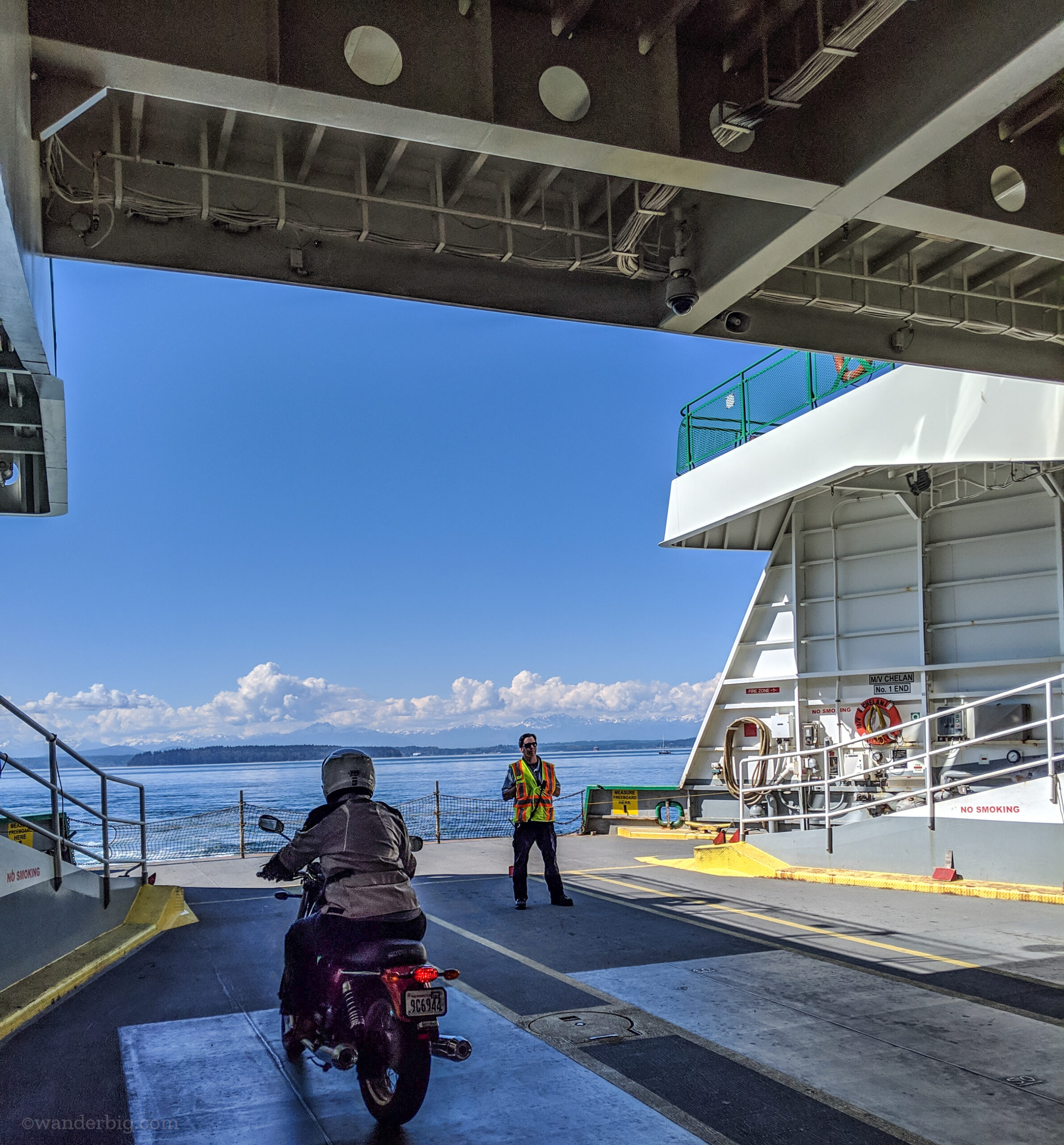 A motorcycle rider at the front of a washington state ferry.