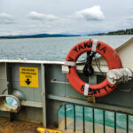 A view of the puget sound landscape over the side of a ferry.