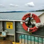A view of the puget sound landscape over the side of a ferry.