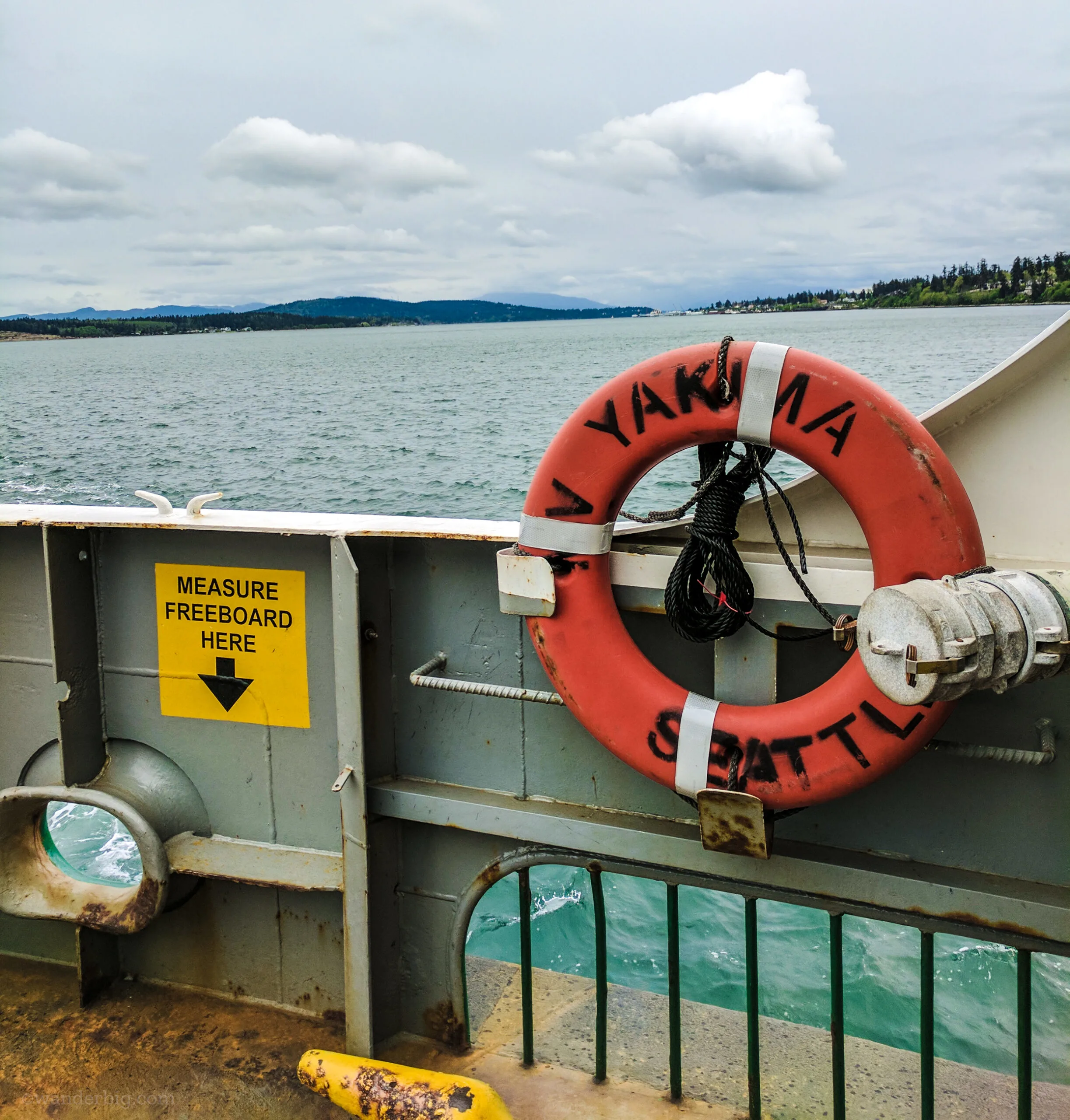 A view of the puget sound landscape over the side of a ferry.