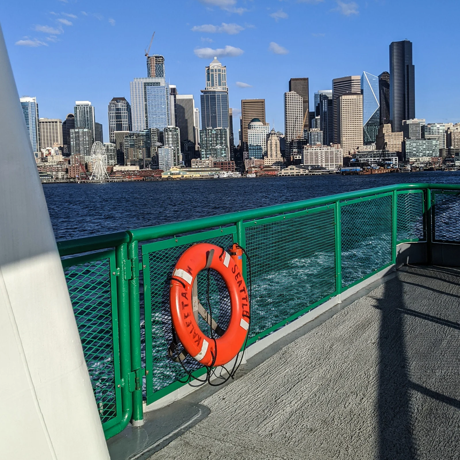 Seattle ferry boat pulling out of downtown seattle.