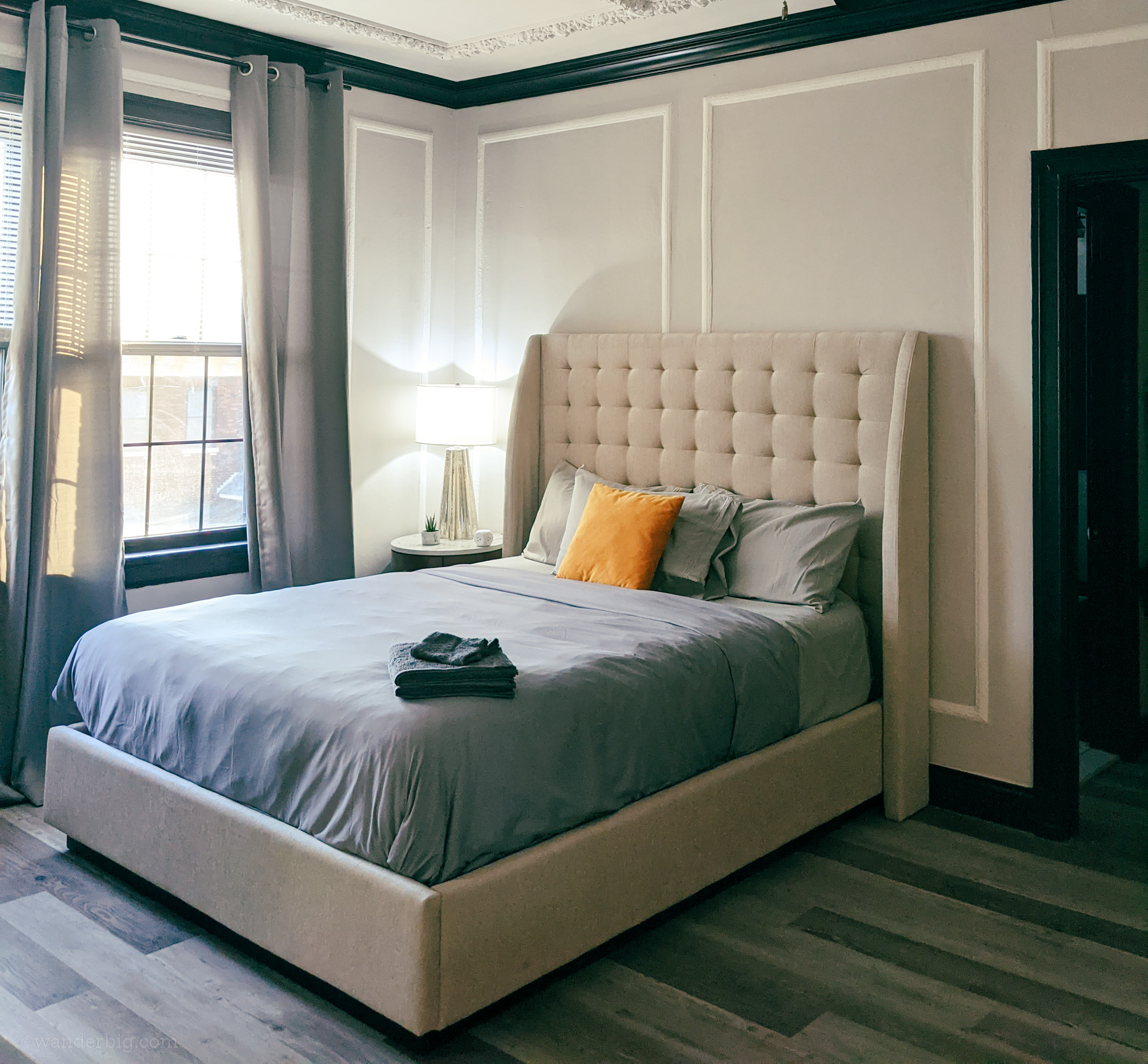 A bed in an airbnb apartment, illustrating the importance of selecting a comfortable space for a monthly airbnb stay.