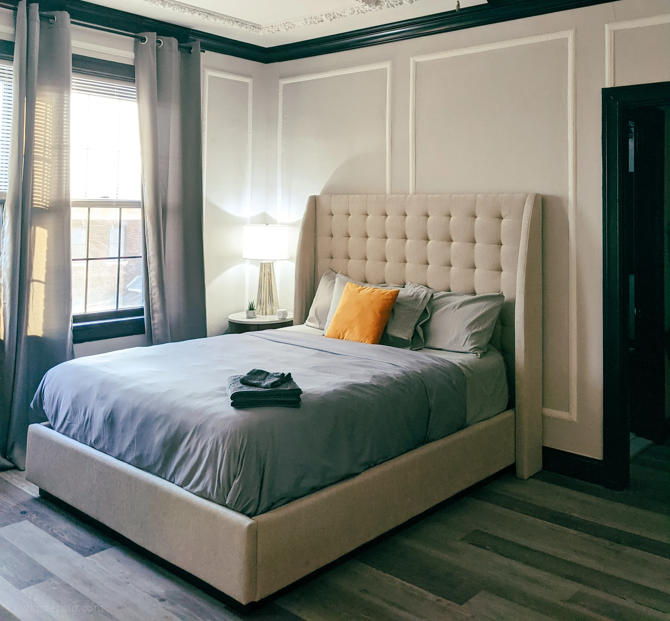 A bed in an airbnb apartment, illustrating the importance of selecting a comfortable space for a monthly airbnb stay.