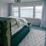 A bed overlooking the puget sound in an airbnb.