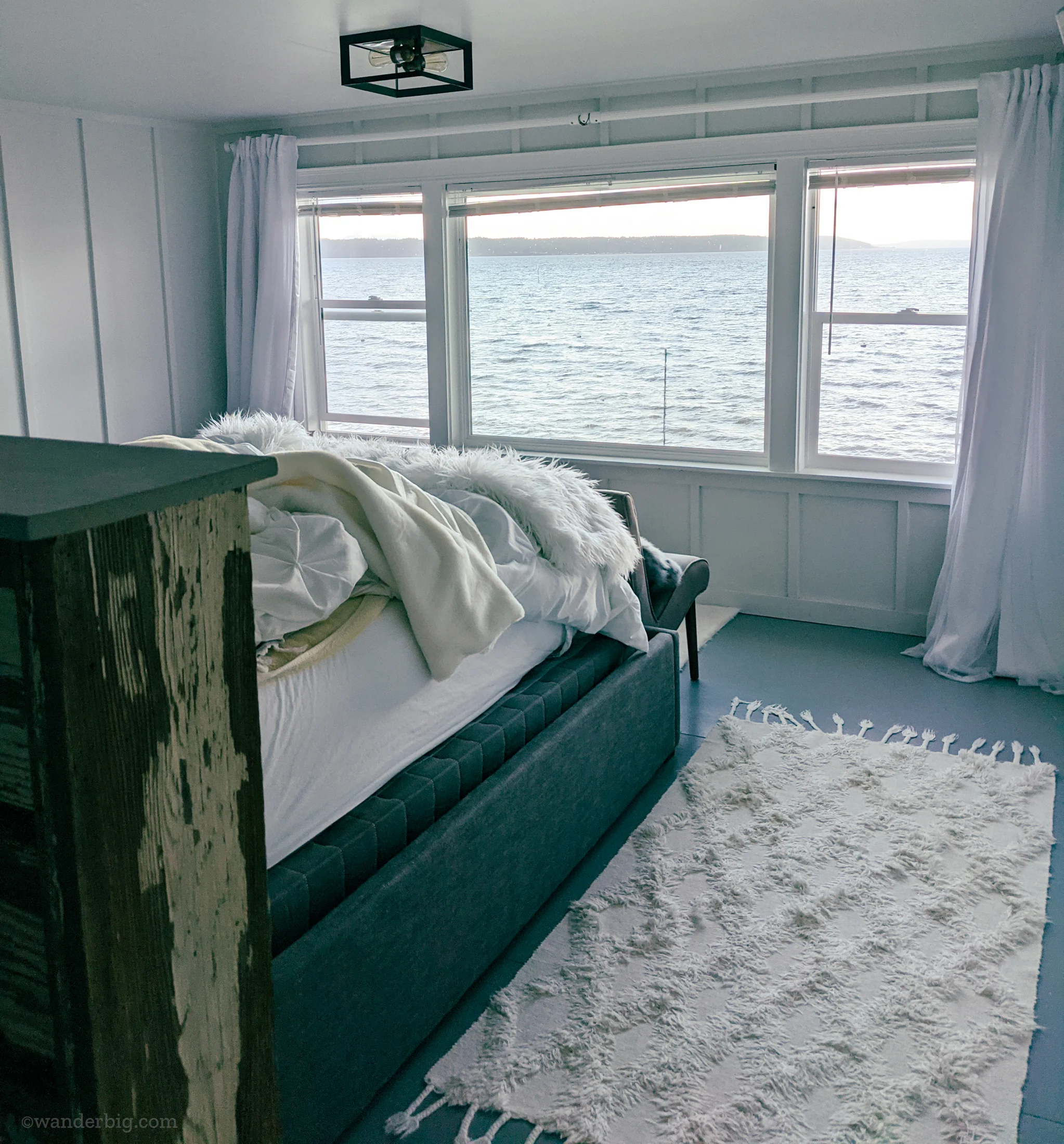 A bed overlooking the puget sound in an airbnb.