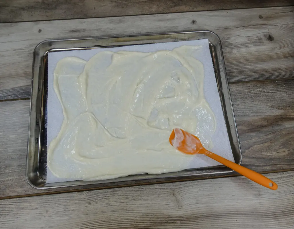 Laundry detergent being spread on a paper towel.